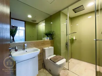 a bathroom with a toilet and a sink and a shower at Vortex Suites KLCC by BlackNest in Kuala Lumpur