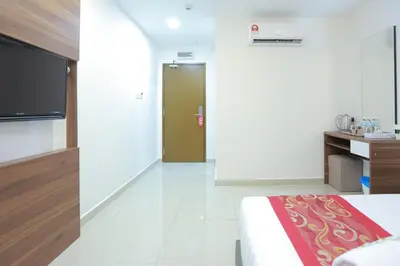 a bedroom with a bed and a door to a kitchen at Bitz Bintang Hotel in Kuala Lumpur