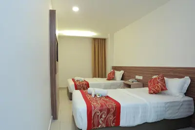 a hotel room with two beds with red and white sheets at Bitz Bintang Hotel in Kuala Lumpur