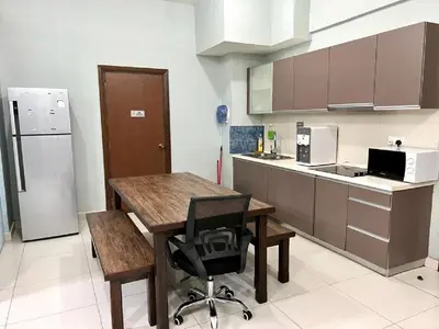 a kitchen with a table and a chair and a refrigerator at Regalia Skypool KLCC in Kuala Lumpur