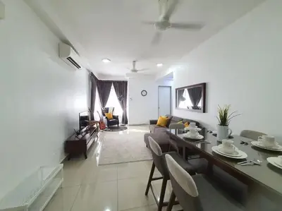 a living room with a dining table and a living room at Rafflesia Condominium by Dahlia Homes in Kuala Lumpur