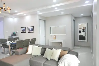 a living room with a couch and a dining room at Rafflesia Condominium by Dahlia Homes in Kuala Lumpur