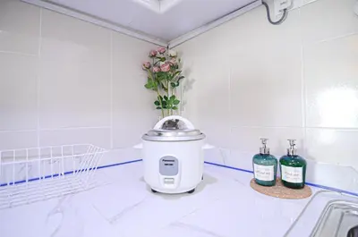 a kitchen with a juicer and two bottles of wine at Rafflesia Condominium by Dahlia Homes in Kuala Lumpur