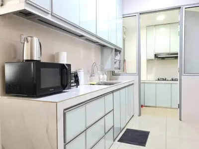 a kitchen with a microwave and a black microwave at Rafflesia Condominium by Dahlia Homes in Kuala Lumpur
