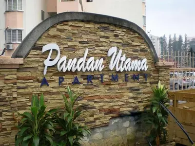 a sign for a restaurant on a brick wall at UMMII Homestay in Ampang