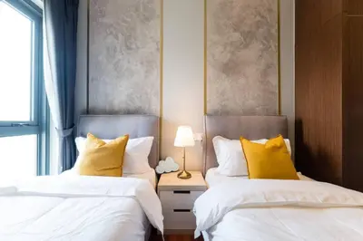 two beds sitting next to each other in a bedroom at TriBeCa 2bedroom 3min walk to bukit bintang 2 rooftop pool in Kuala Lumpur