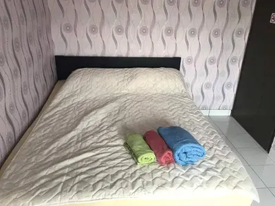 two pillows are laying on a bed in a room at Mahasa Homestay Kuala Lumpur in Kuala Lumpur