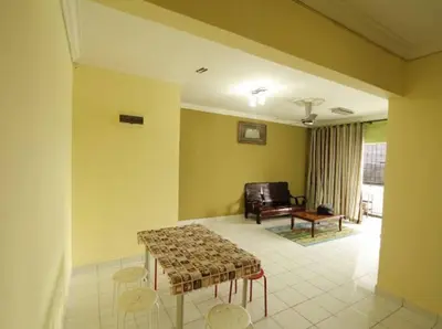 a living room with a table and chairs and a couch at Mahasa Homestay Kuala Lumpur in Kuala Lumpur