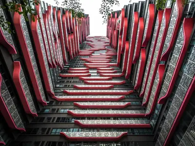 a stairway with red chairs in a building at Arte Plus Jalan Ampang by Airhost in Kuala Lumpur