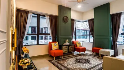 a living room with green walls and red chairs and windows at Arte Plus Jalan Ampang by Airhost in Kuala Lumpur