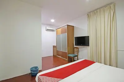 a hotel room with a bed and a tv at Hotel O Shalimar in Kuala Lumpur