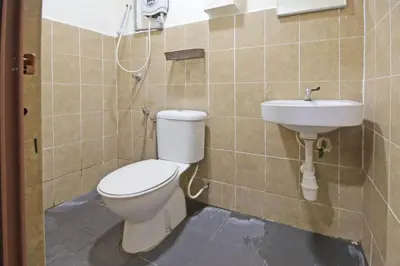 a bathroom with a toilet and a sink at Hotel O Shalimar in Kuala Lumpur