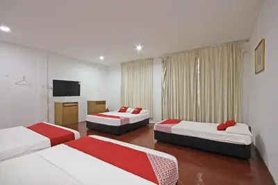 a hotel room with two beds and a television at Hotel O Shalimar in Kuala Lumpur