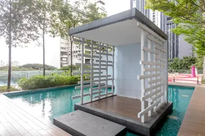 a tiny house with a ladder next to a swimming pool at Rex Ollie @ The Elements Ampang in Kuala Lumpur