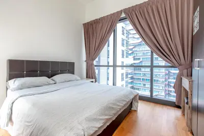 a bedroom with a large bed and a large window at Rex Ollie @ The Elements Ampang in Kuala Lumpur