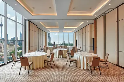a conference room with tables and chairs and windows at Four Points by Sheraton Kuala Lumpur, Chinatown in Kuala Lumpur