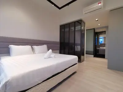 a bedroom with a large white bed with white pillows at ExpressionZ Suites KLCC in Kuala Lumpur