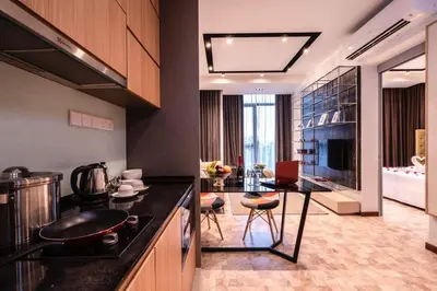 a kitchen with a counter and a table in it at ExpressionZ Suites KLCC in Kuala Lumpur