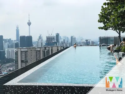 a infinity pool on the roof of a building with a city at KLCC View Expressionz Family Loft by WGS in Kuala Lumpur