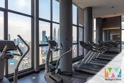 a gym with treadmills and ellipticals in a building at KLCC View Expressionz Family Loft by WGS in Kuala Lumpur
