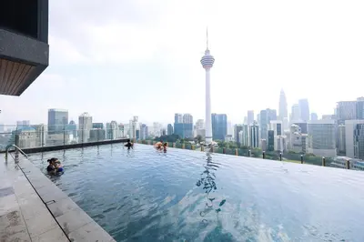 a swimming pool on the roof of a building with a city at Ceylonz Suites by MyKey in Kuala Lumpur