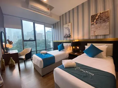 a hotel room with two beds and a window at Ceylonz Suites by MyKey in Kuala Lumpur
