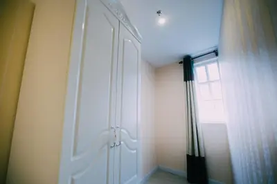 a white door in a room with a window at Hotel Venice in Kuala Lumpur