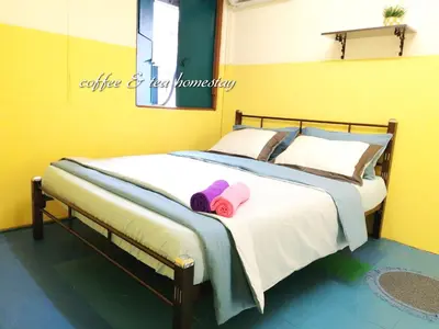 a bedroom with a bed with two slippers on it at Coffee & Tea Homestay 2 in Kuala Lumpur