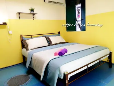 a bed with a pink teddy bear laying on it at Coffee & Tea Homestay 2 in Kuala Lumpur