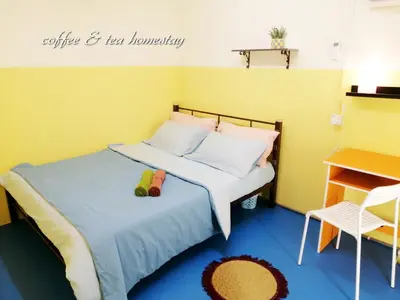 a bedroom with a bed with two shoes on it at Coffee & Tea Homestay 2 in Kuala Lumpur
