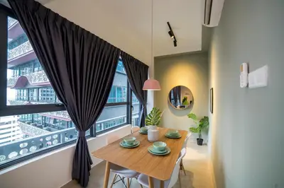 a dining room with a table and a large window at Arte Plus KLCC Designer Suites by Cobnb in Kuala Lumpur