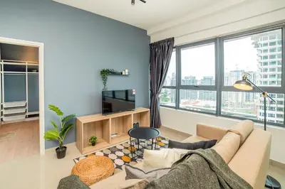 a living room with a couch and a tv at Arte Plus KLCC Designer Suites by Cobnb in Kuala Lumpur