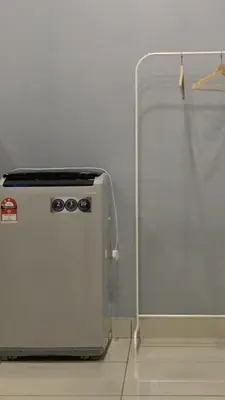 a small refrigerator sitting next to a wall at 7 mins KLCC next to Hospital Gleneagle in Kuala Lumpur