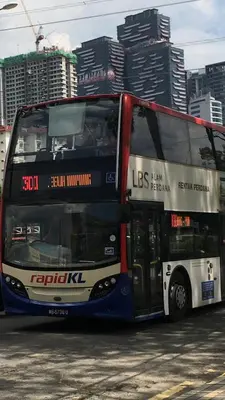 a double decker bus parked in a parking lot at 7 mins KLCC next to Hospital Gleneagle in Kuala Lumpur