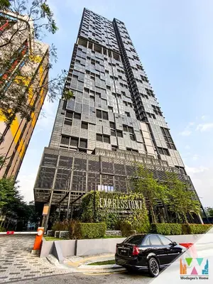 a car parked in front of a tall building at WGS Suites at KLCC in Kuala Lumpur