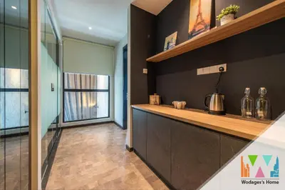 a kitchen with black walls and a counter at WGS Suites at KLCC in Kuala Lumpur