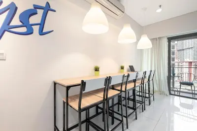 a bar in a room with a row of chairs at Amethyst KLCC in Kuala Lumpur