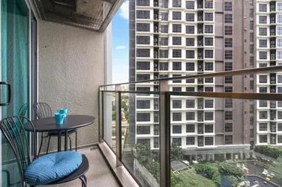 a balcony with a table and chairs and a view of a building at Amethyst KLCC in Kuala Lumpur