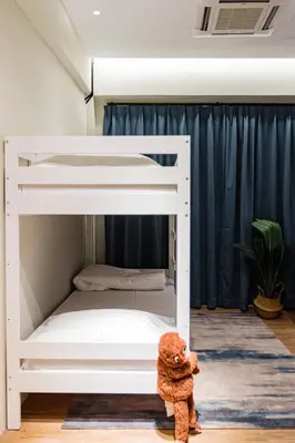 a teddy bear standing next to a bunk bed at Urban Living Residence in Kuala Lumpur