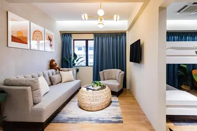 a living room with a couch and a bed at Urban Living Residence in Kuala Lumpur