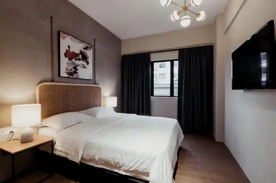 a bedroom with a white bed and a window at Urban Living Residence in Kuala Lumpur