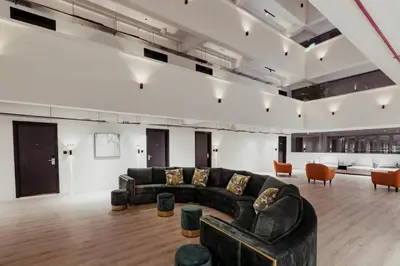 a living room with a black couch and chairs at Urban Living Residence in Kuala Lumpur