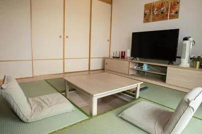 a living room with a coffee table and a tv at Kisetsu no ie, KLCC Kuala Lumpur in Kuala Lumpur