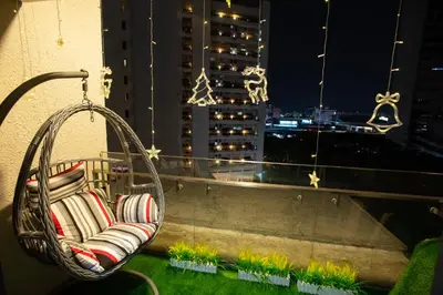 a rattan chair sitting on a balcony at night at Kisetsu no ie, KLCC Kuala Lumpur in Kuala Lumpur