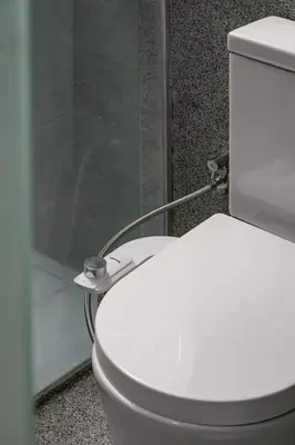 a white toilet in a bathroom with a shower at BRYQS Hotel in Kuala Lumpur