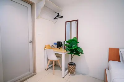 a room with a desk with a mirror and a plant at Swing & Pillows - KL Pekeliling in Kuala Lumpur