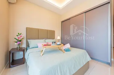 a bedroom with a bed with a table on it at Dorsett Residences Sri Hartamas [5 Star Suites] in Kuala Lumpur