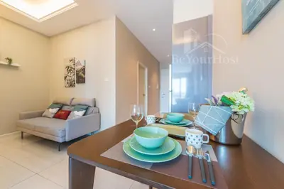 a dining room with a table with plates and wine glasses at Dorsett Residences Sri Hartamas [5 Star Suites] in Kuala Lumpur