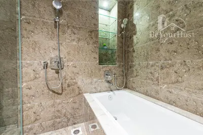 a bathroom with a shower and a bath tub at Dorsett Residences Sri Hartamas [5 Star Suites] in Kuala Lumpur