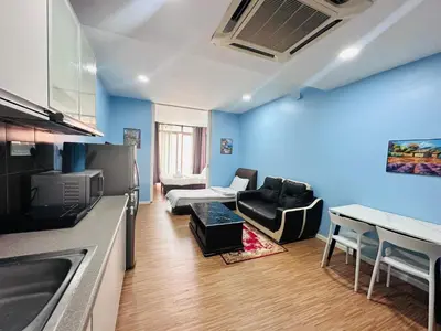 a kitchen and living room with a couch and a table at Taragon Apartment - KL ,Malaysia in Kuala Lumpur